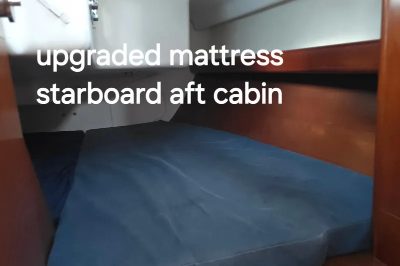 Slide: The Image of 2003 Beneteau First 36.7 sailboat interior with wooden cabin and storage space. - 20