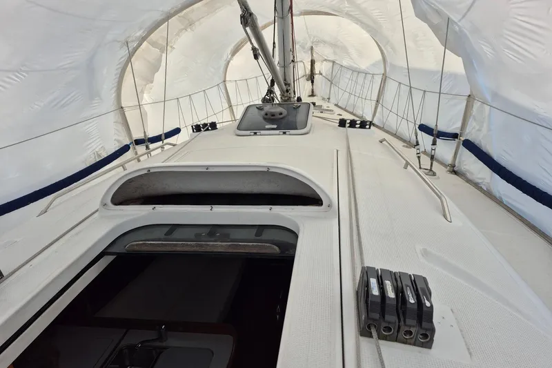 Slide: The Image of Beneteau First 36.7 sailboat deck under protective cover, showcasing hatch and rigging, 2003 model. - 9