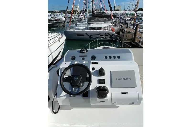 Slide: The Image of 2025 Fairline Squadron 50 yacht helm with Garmin navigation system at a marina. - 11