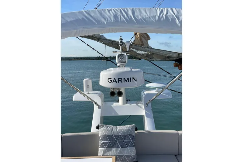 Slide: The Image of 2025 Fairline Squadron 50 yacht with Garmin navigation system on calm waters. - 13