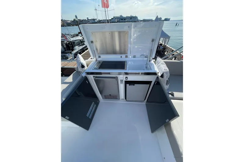 Slide: The Image of Outdoor kitchenette on 2025 Fairline Squadron 50 yacht, featuring sink and storage. - 14