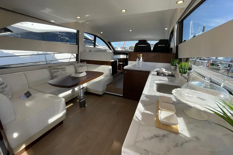 Slide: The Image of Luxurious interior of 2025 Fairline Squadron 50 yacht with elegant seating and modern kitchen. - 17