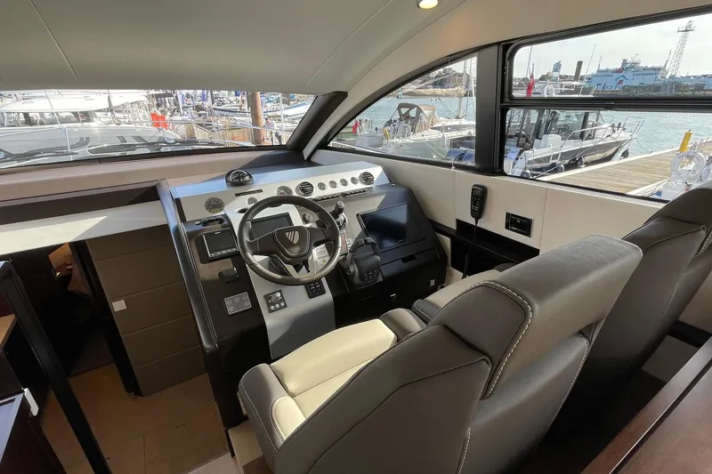 Slide: The Image of 2025 Fairline Squadron 50 yacht helm with modern controls and luxurious seating. - 22