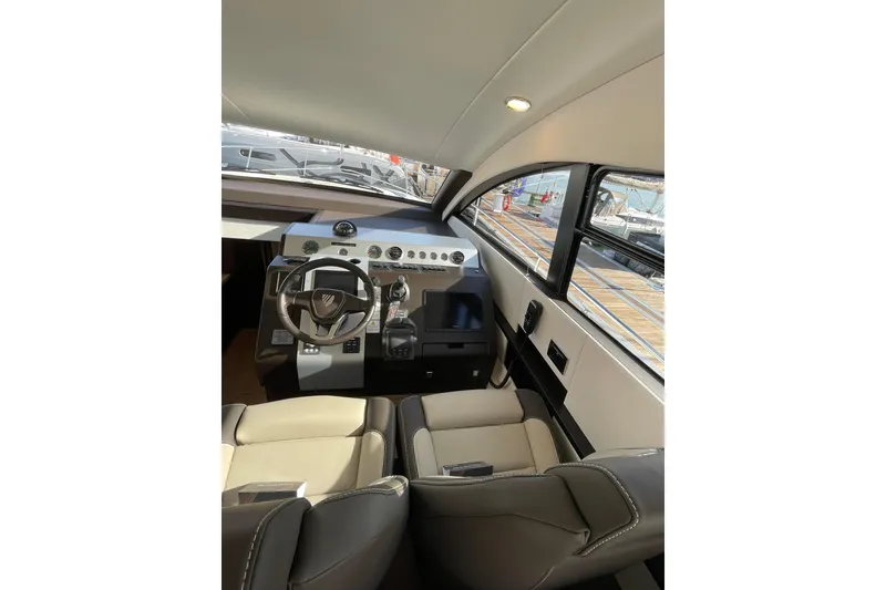 Slide: The Image of Interior cockpit of 2025 Fairline Squadron 50 yacht, featuring modern steering and controls. - 23