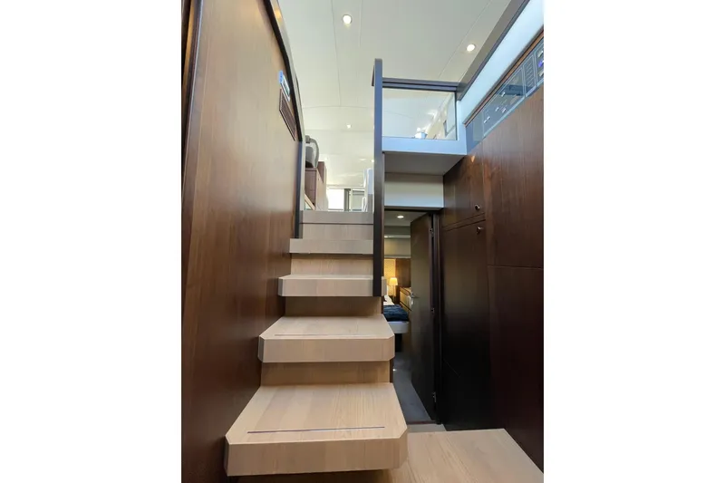 Slide: The Image of Staircase inside 2025 Fairline Squadron 50 yacht, featuring modern wood design and elegant lighting. - 25