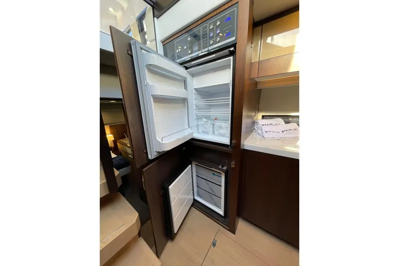 Slide: The Image of Modern kitchen area in 2025 Fairline Squadron 50 yacht with open fridge and freezer. - 28