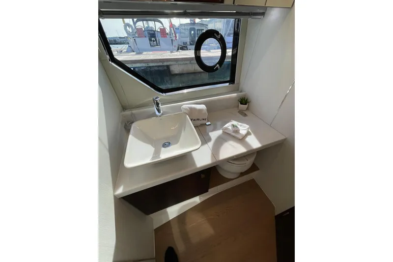 Slide: The Image of Modern bathroom interior of 2025 Fairline Squadron 50 yacht with sink and window view. - 34