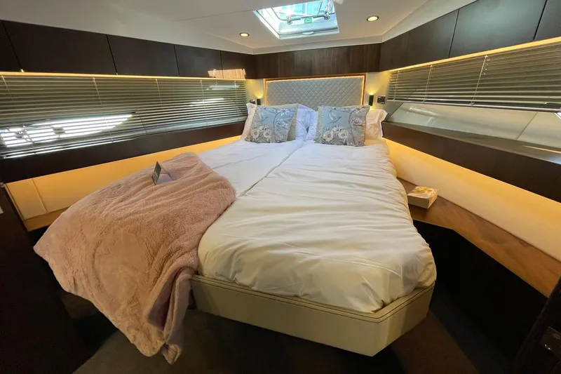 Slide: The Image of Luxurious bedroom interior of 2025 Fairline Squadron 50 yacht with elegant bedding and ambient lighting. - 36