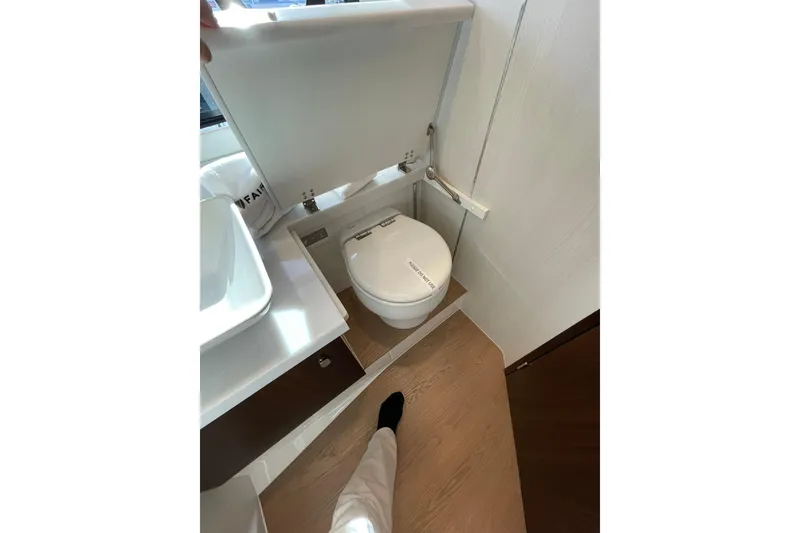 Slide: The Image of Luxury bathroom in 2025 Fairline Squadron 50 yacht, featuring modern toilet design. - 37