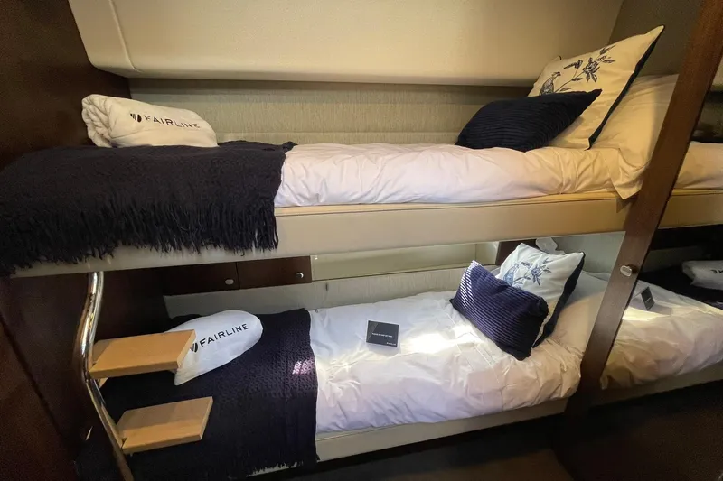 Slide: The Image of 2025 Fairline Squadron 50 yacht interior with cozy bunk beds and elegant decor. - 39