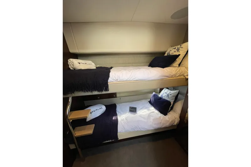 Slide: The Image of Bunk beds in 2025 Fairline Squadron 50 yacht cabin, featuring cozy bedding and elegant design. - 40