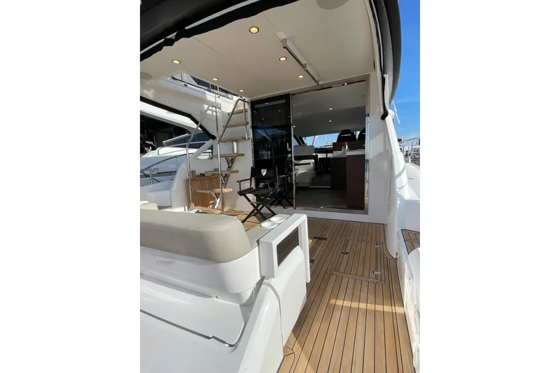 Slide: The Image of Luxury Fairline Squadron 50 yacht deck, 2025 model, featuring elegant seating and modern design. - 8