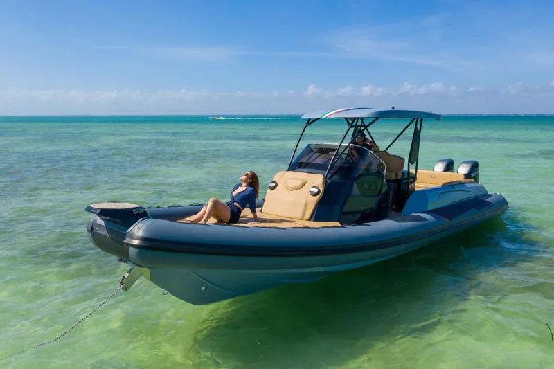 Slide: The Image of 2025 Ranieri CAYMAN 38.0 EXECUTIVE boat anchored in clear turquoise water. - 1