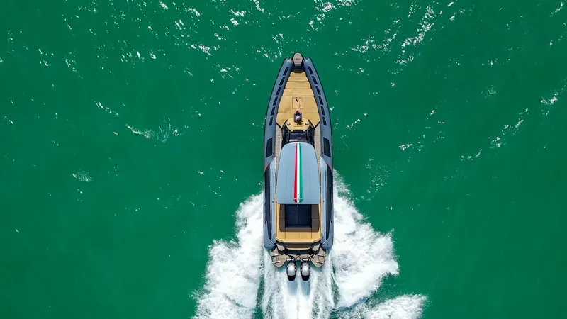 Slide: The Image of Aerial view of 2025 Ranieri CAYMAN 38.0 EXECUTIVE boat cruising on turquoise water. - 4