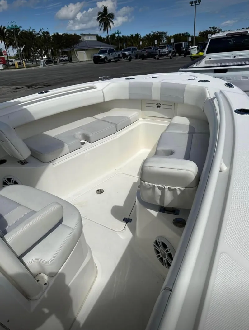 Slide: The Image of 2020 Mako 236 CC boat interior with white seating and open deck. - 11