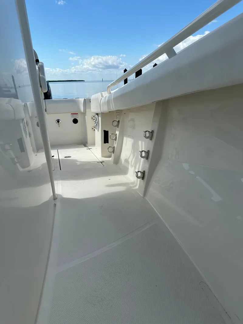 Slide: The Image of 2020 Mako 236 CC boat interior with clear sky and water view. - 22