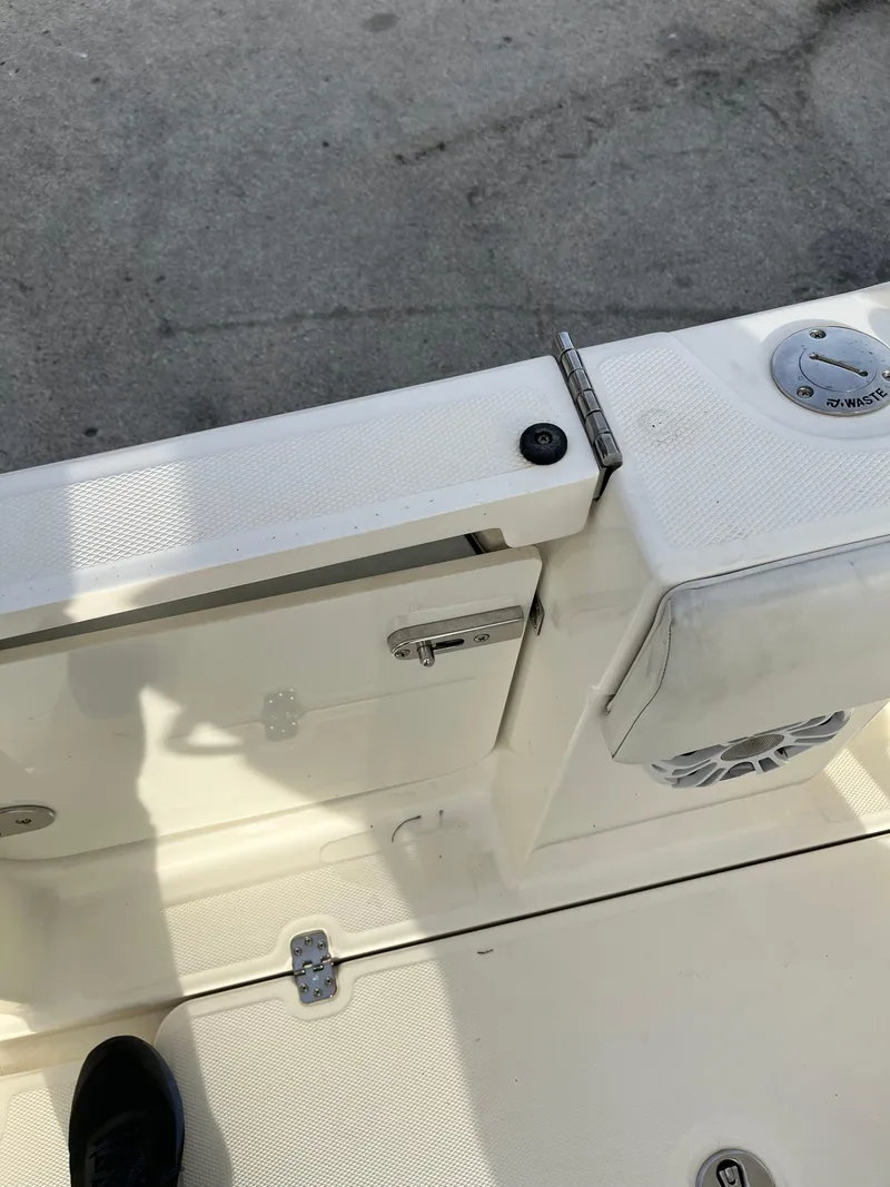 Slide: The Image of 2020 Mako 236 CC boat deck with latch and speaker detail. - 24