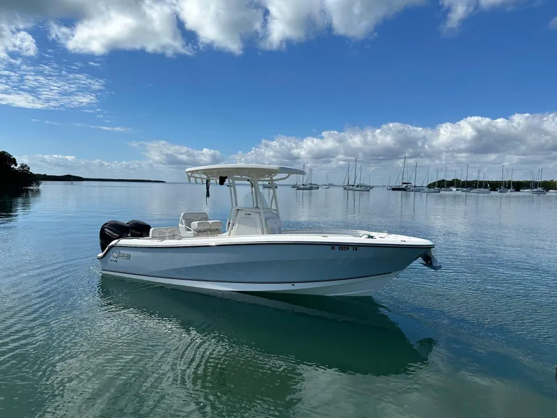 Slide: The Image of 2020 Mako 236 CC boat on calm water under a partly cloudy sky. - 3