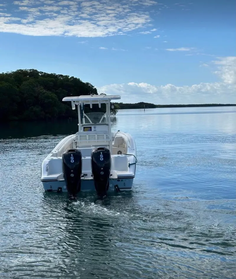 Slide: The Image of 2020 Mako 236 CC boat with dual engines on calm water. - 6