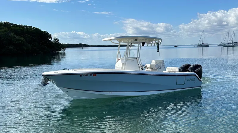 Slide: The Image of 2020 Mako 236 CC boat on calm water with clear sky background. - 7