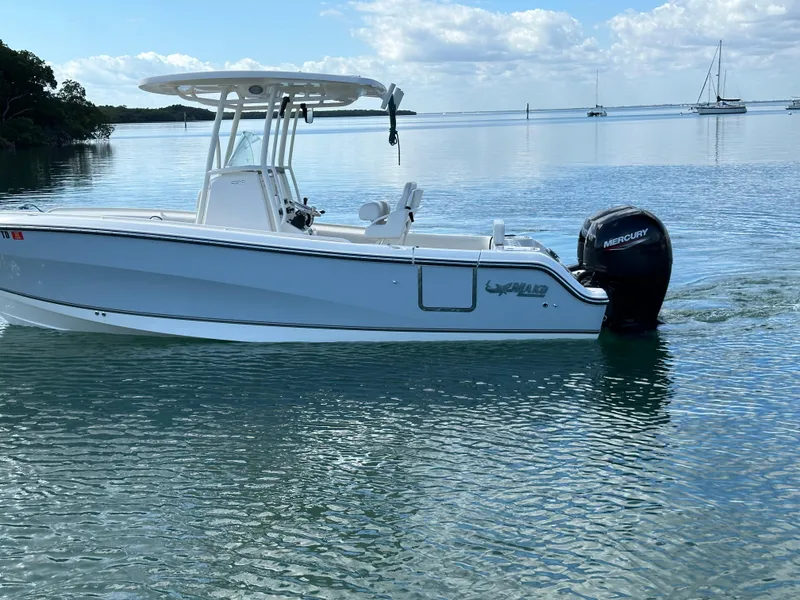 Slide: The Image of 2020 Mako 236 CC boat on calm water with Mercury outboard motor. - 8