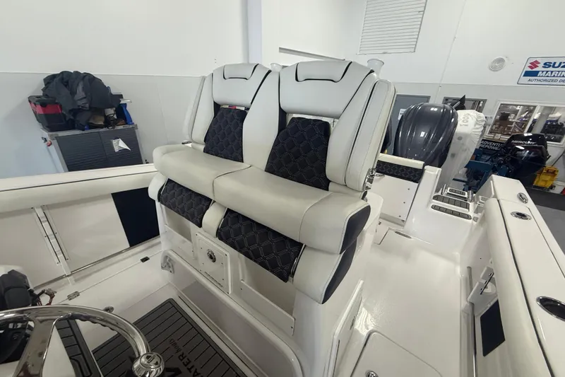 Slide: The Image of 2022 Tidewater 272 CC Adventure boat interior with dual cushioned seats. - 11