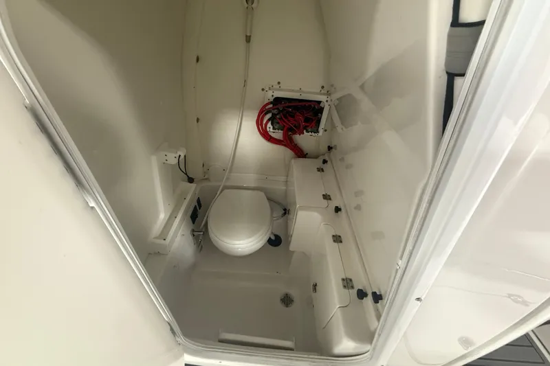 Slide: The Image of 2022 Tidewater 272 CC Adventure boat interior with toilet and storage compartments. - 12