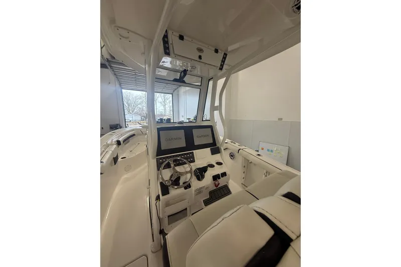 Slide: The Image of 2022 Tidewater 272 CC Adventure boat interior with dual Garmin displays and steering wheel. - 14