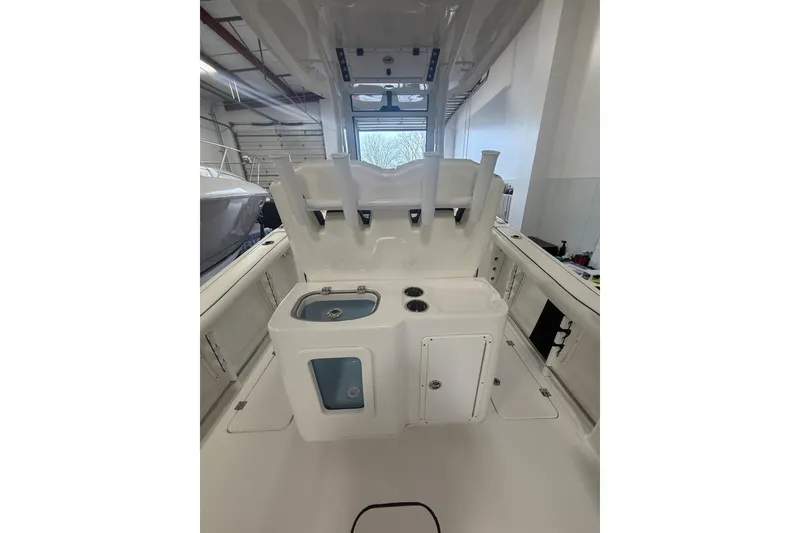 Slide: The Image of 2022 Tidewater 272 CC Adventure boat interior with fishing rod holders and storage compartments. - 16
