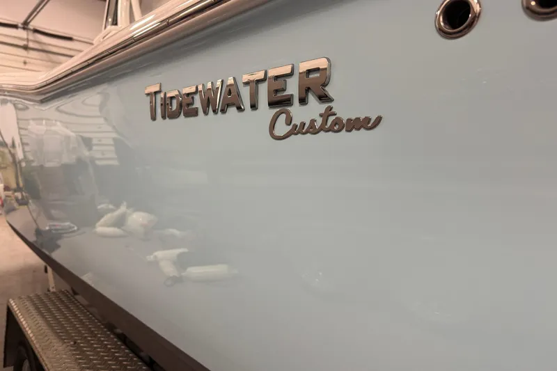 Slide: The Image of 2022 Tidewater 272 CC Adventure boat with custom branding in a garage setting. - 19