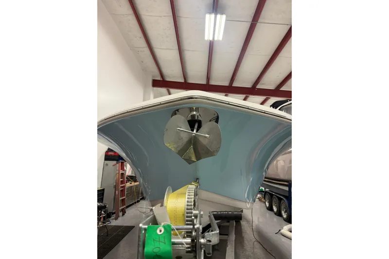 Slide: The Image of 2022 Tidewater 272 CC Adventure boat in a warehouse, viewed from below. - 21