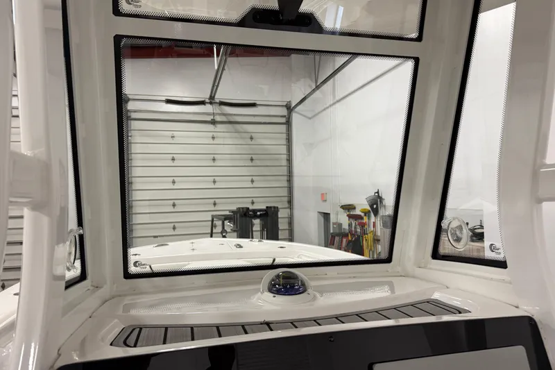Slide: The Image of Interior view of 2022 Tidewater 272 CC Adventure boat, showcasing windshield and compass. - 23