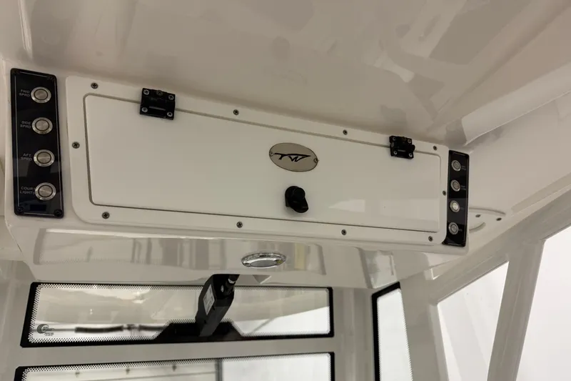 Slide: The Image of 2022 Tidewater 272 CC Adventure boat console with control panel and storage compartment. - 24