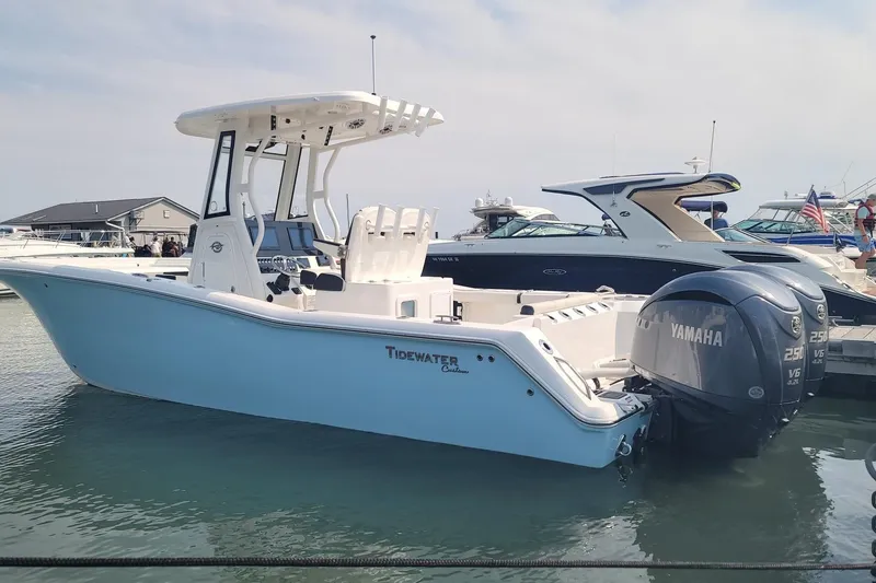 Slide: The Image of 2022 Tidewater 272 CC Adventure boat docked with twin Yamaha engines. - 3