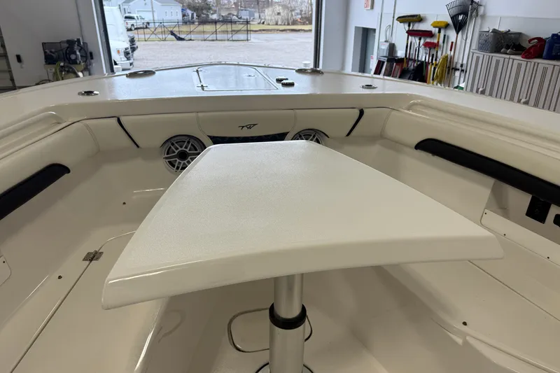 Slide: The Image of 2022 Tidewater 272 CC Adventure boat interior with table and seating area. - 6