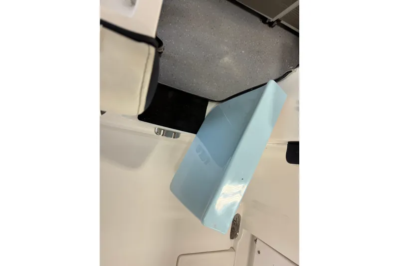 Slide: The Image of 2022 Tidewater 272 CC Adventure boat interior detail with light blue compartment. - 9