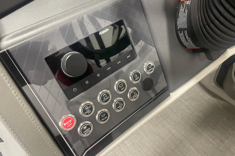 Slide: The Image of 2024 Tahoe Pontoon Cascade Versatile Rear Bench control panel with audio system and buttons. - 22