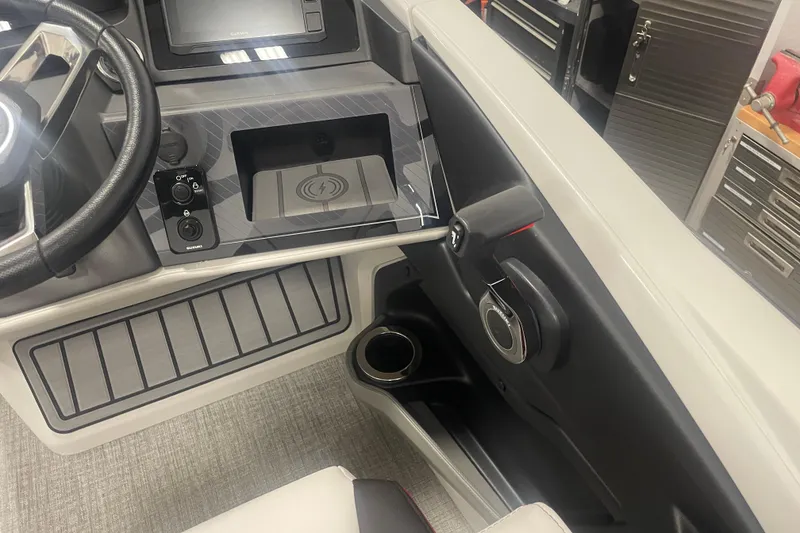 Slide: The Image of 2024 Tahoe Pontoon Cascade Versatile Rear Bench dashboard with steering wheel and control panel. - 33