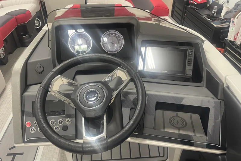 Slide: The Image of 2024 Tahoe Pontoon Cascade Versatile Rear Bench dashboard with steering wheel and navigation display. - 34