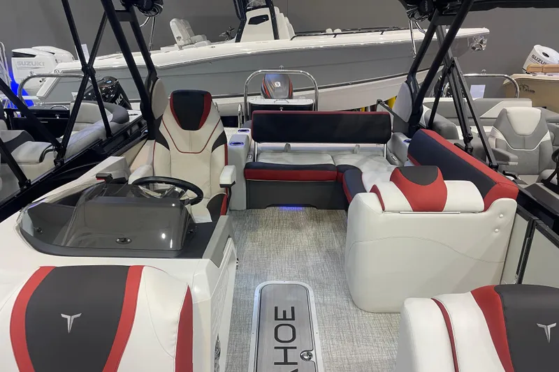 Slide: The Image of 2024 Tahoe Pontoon Cascade Versatile Rear Bench interior with modern seating and steering console. - 4