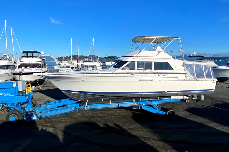 The Image of 1984 Bertram 54 Convertible on a blue boat trailer at the harbor. - 0