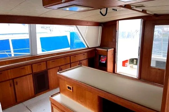 Slide: The Image of Interior of 1984 Bertram 54 Convertible yacht with wooden furnishings. - 11