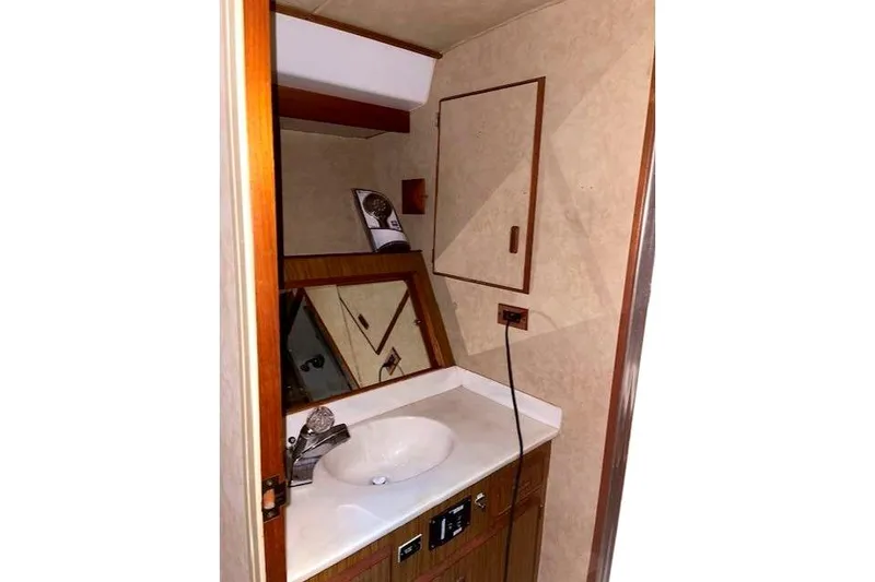 Slide: The Image of Interior of 1984 Bertram 54 Convertible boat, bathroom with sink. - 21