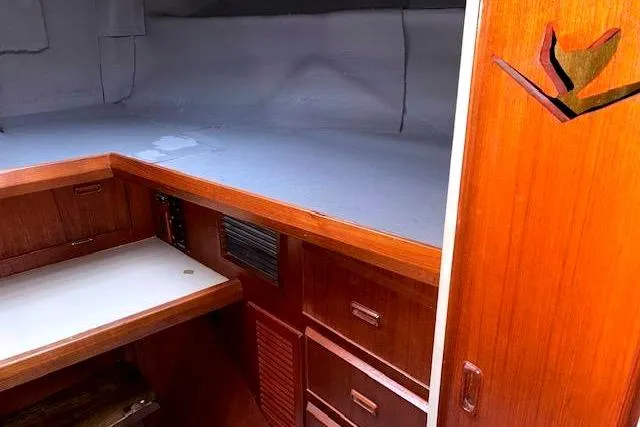 Slide: The Image of Interior of a 1984 Bertram 54 Convertible yacht with wooden furnishings. - 24