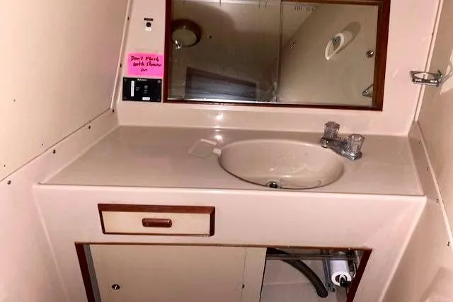 Slide: The Image of 1984 Bertram 54 Convertible bathroom with sink and mirror. - 25