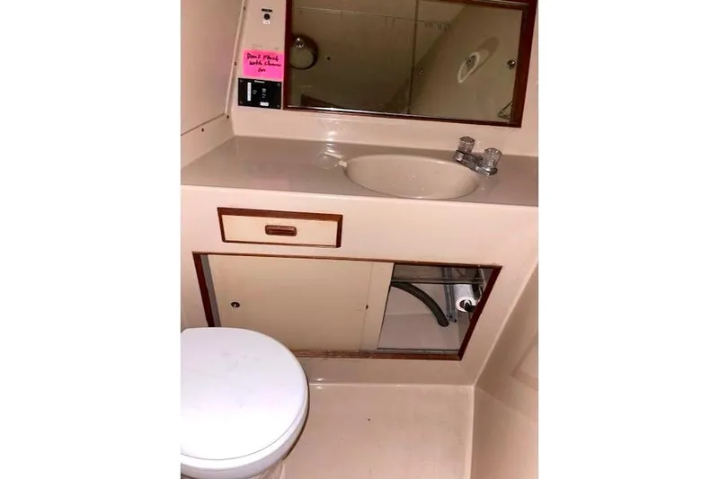 Slide: The Image of Bathroom in 1984 Bertram 54 Convertible, featuring sink and mirror. - 26