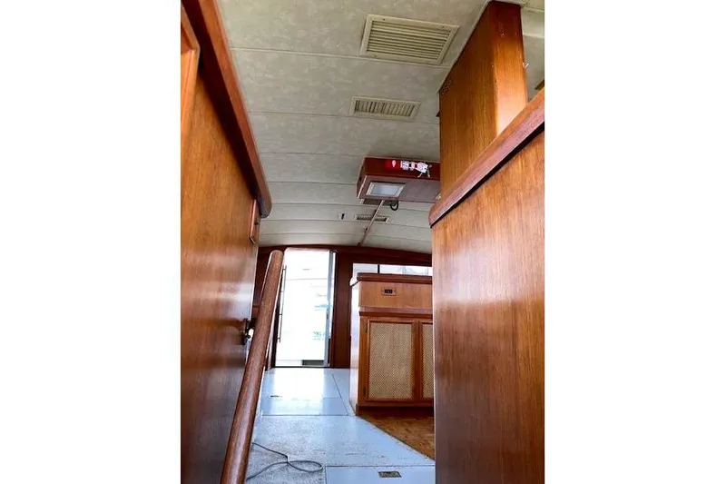 Slide: The Image of Interior of a 1984 Bertram 54 Convertible yacht, featuring wood paneling. - 30