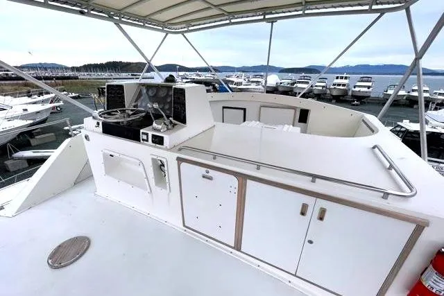 Slide: The Image of 1984 Bertram 54 Convertible yacht helm with marina view. - 31