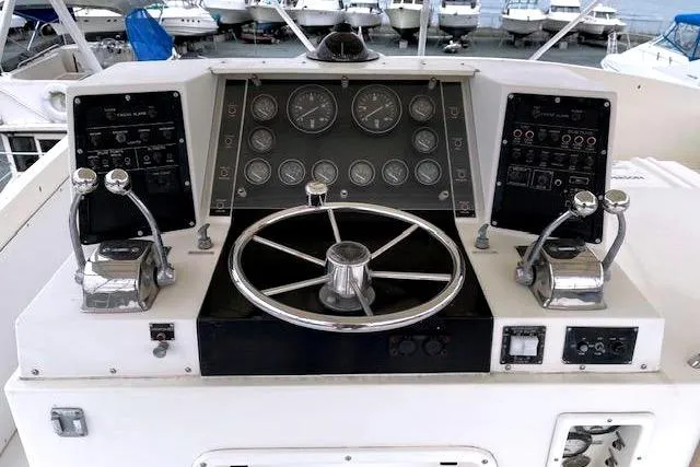 Slide: The Image of Helm of a 1984 Bertram 54 Convertible boat in harbor. - 33