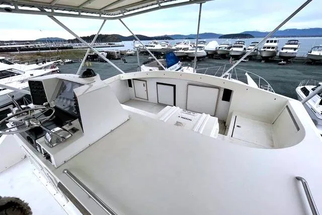 Slide: The Image of 1984 Bertram 54 Convertible yacht at marina with sea view. - 34